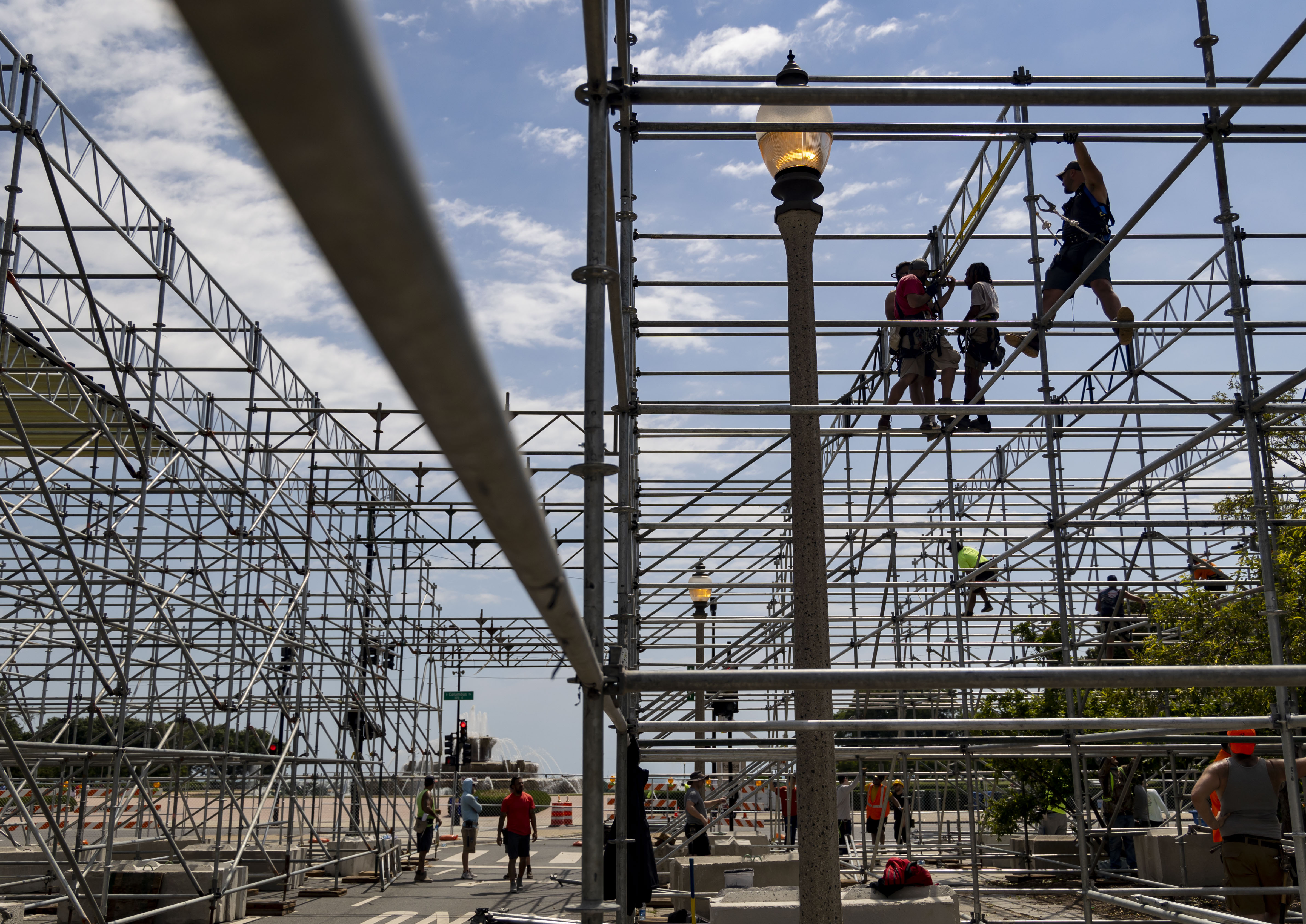 Workers construct a three-story grandstand, which includes the Skyline premium hospitality club overlooking pit road and the start/finish line at Buckingham Fountain, for the NASCAR Chicago Street Race on June 13, 2024, on Ida B. Wells Drive in Grant Park. (Brian Cassella/Chicago Tribune)