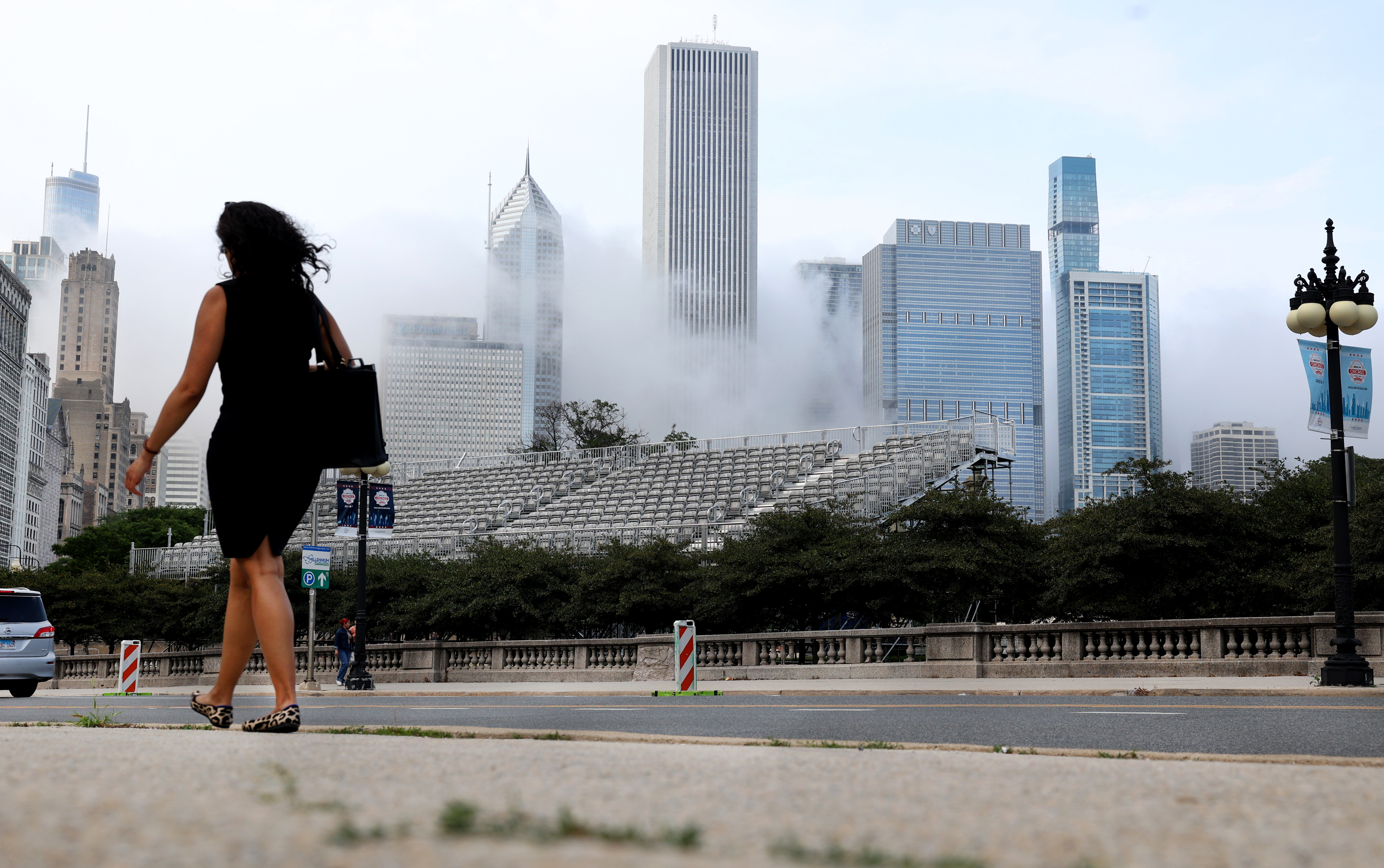 A person walks near temporary viewing stands rising along Michigan Avenue on  June 20, 2024 in advance of the upcoming NASCAR Chicago Street Race weekend. The event is scheduled to take place July 6-7. (Chris Sweda/Chicago Tribune)