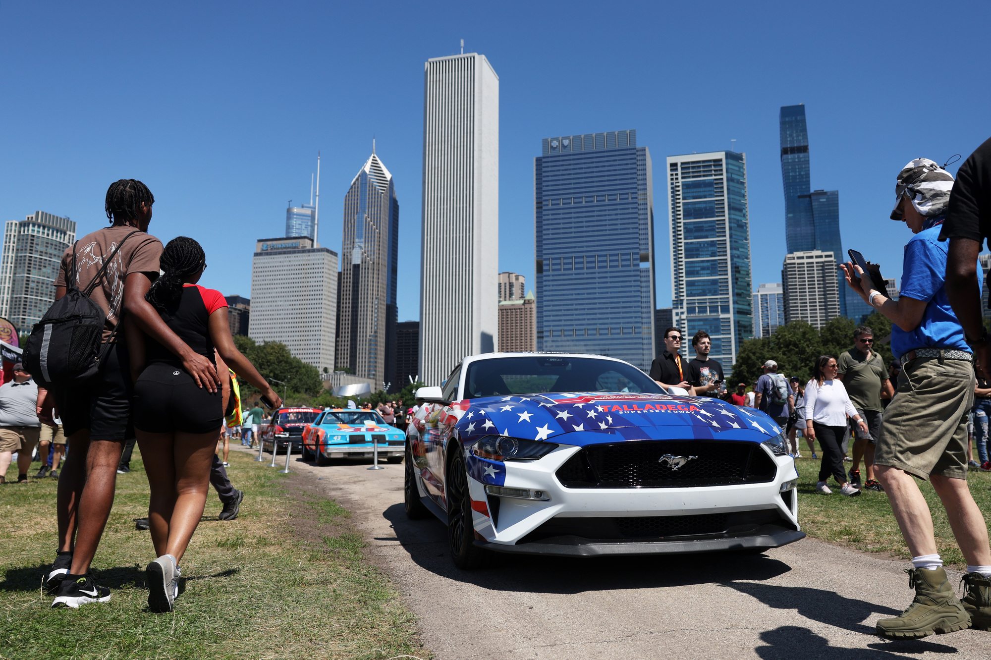 Race cars are on display in the NASCAR Village at Butler Field before the Xfinity Series race Saturday, July 6, 2024, in Chicago. (John J. Kim/Chicago Tribune)