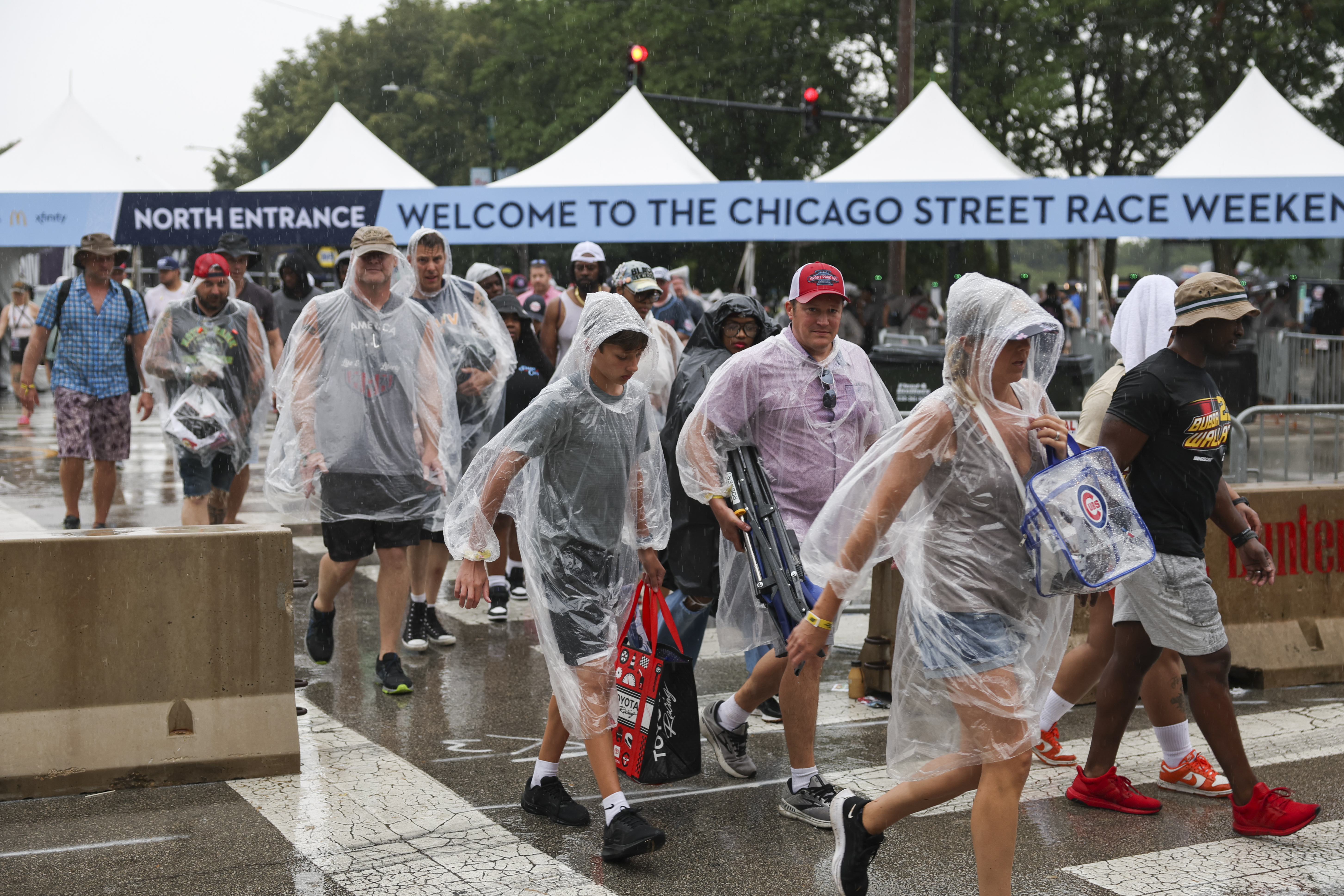 Fans leave Grant Park during a rain delay at the NASCAR Chicago Street Race on July 7, 2024. (Eileen T. Meslar/Chicago Tribune)