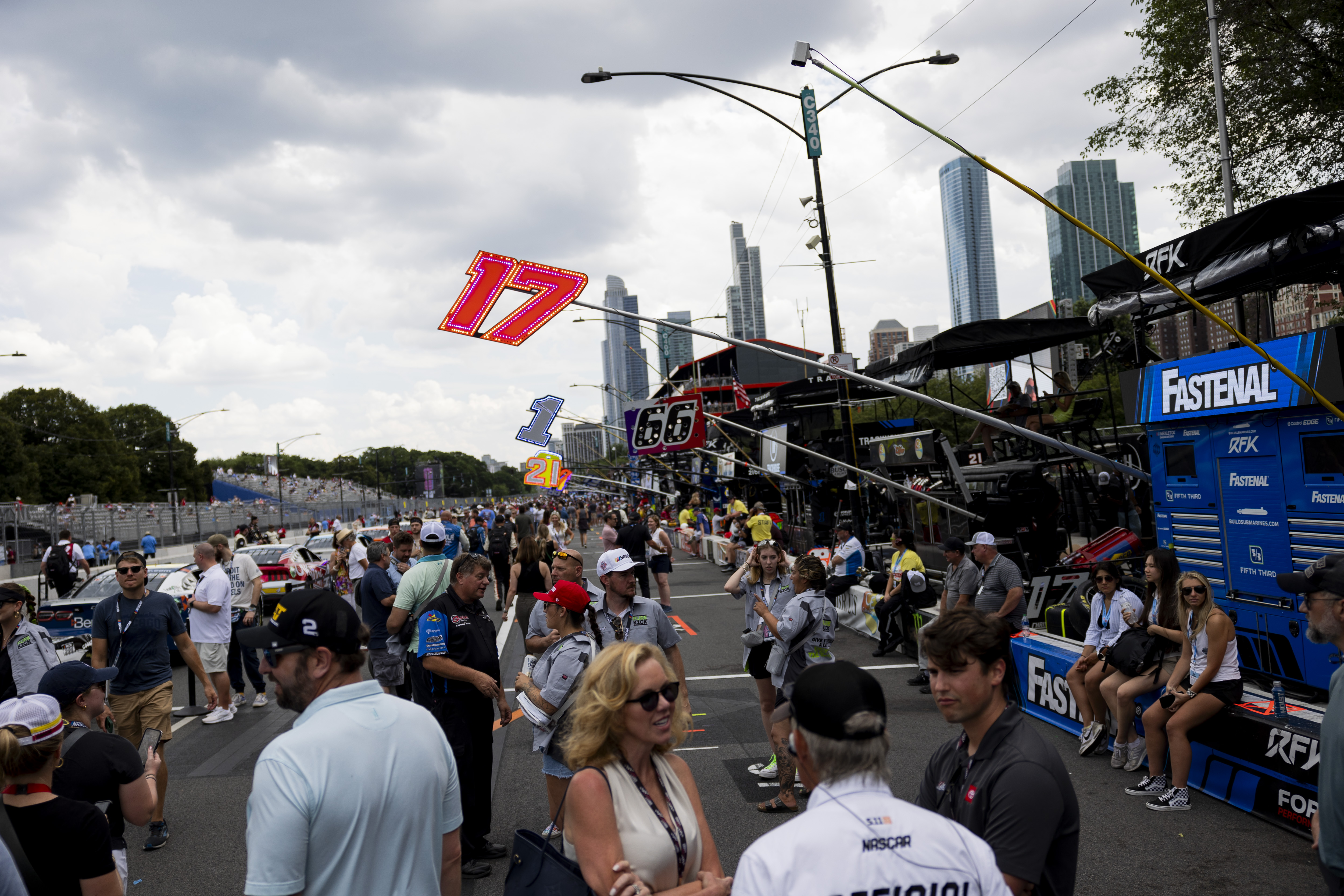 People walk in pit road during the second day of the NASCAR Street Race on Sunday, July 7, 2024, at Grant Park in Chicago. (Vincent Alban/Chicago Tribune)