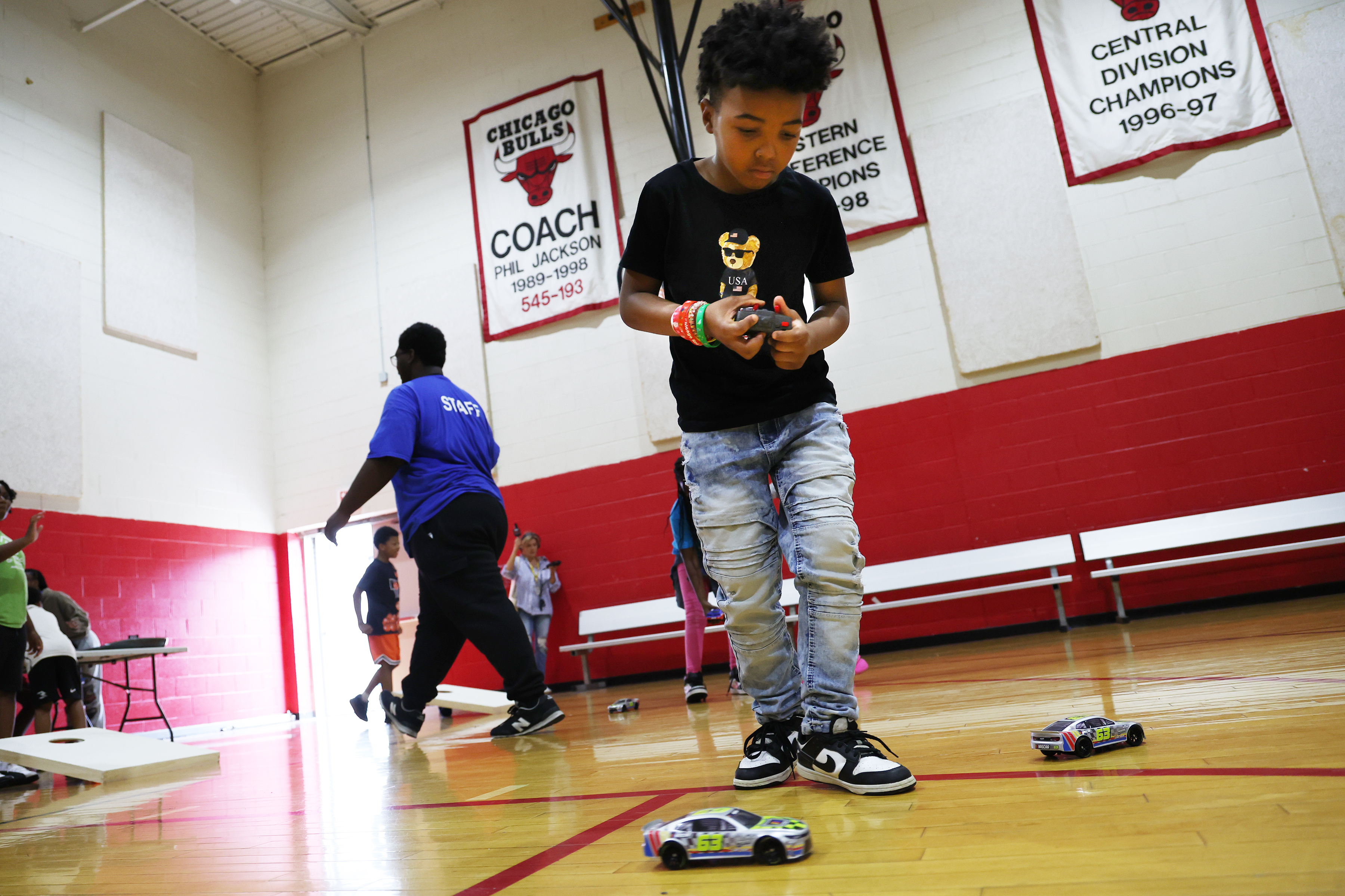 Aiden Marshall, age 9, plays with a radio-controlled toy car at a NASCAR-themed event in the James Jordan Boys & Girls Club in Chicago on Tuesday, July 2, 2024. (Terrence Antonio James/Chicago Tribune)