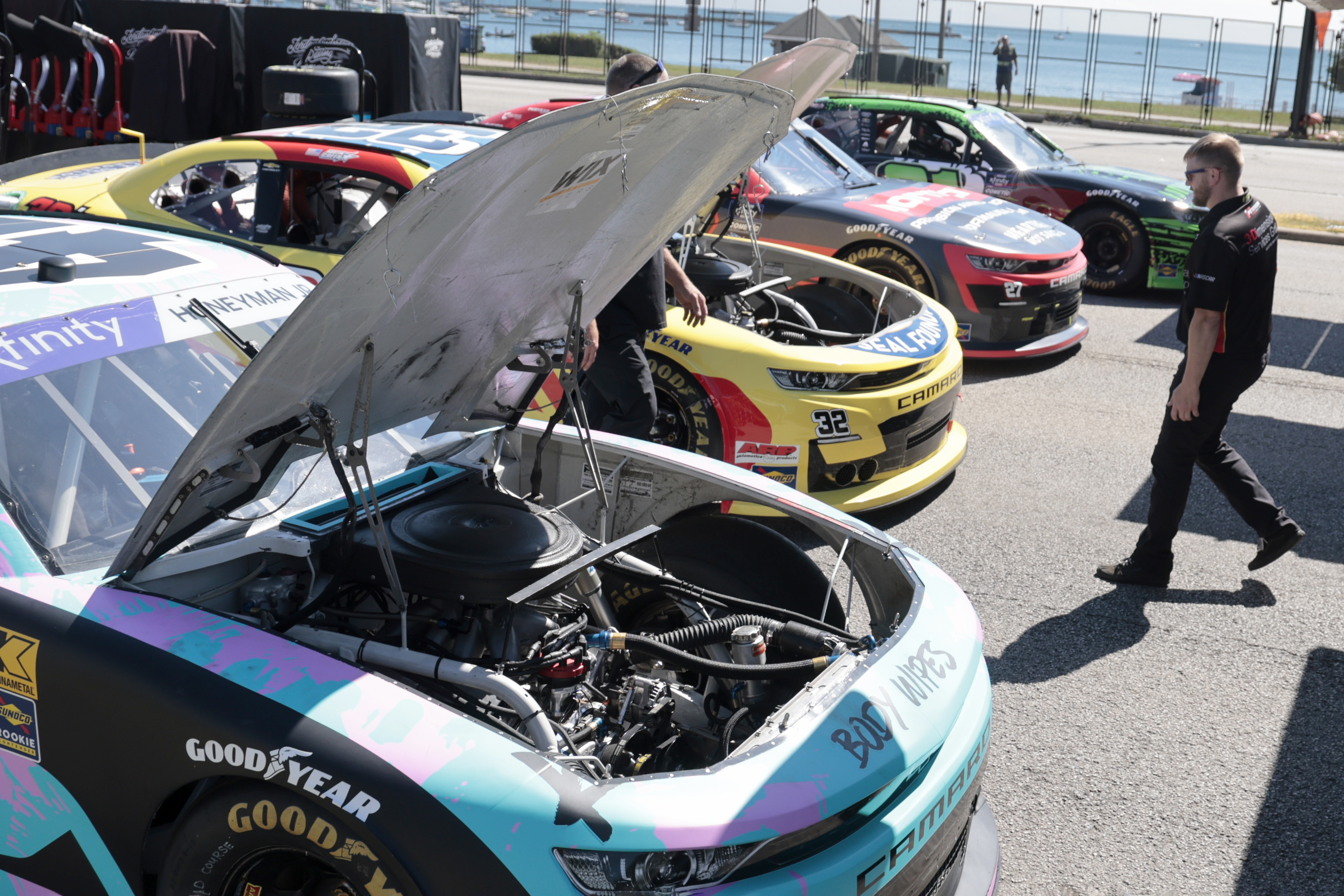 Race cars are looked over after being unloaded off trucks, July 5, 2024, in preparation for NASCAR Chicago Street Race. (Antonio Perez/Chicago Tribune)