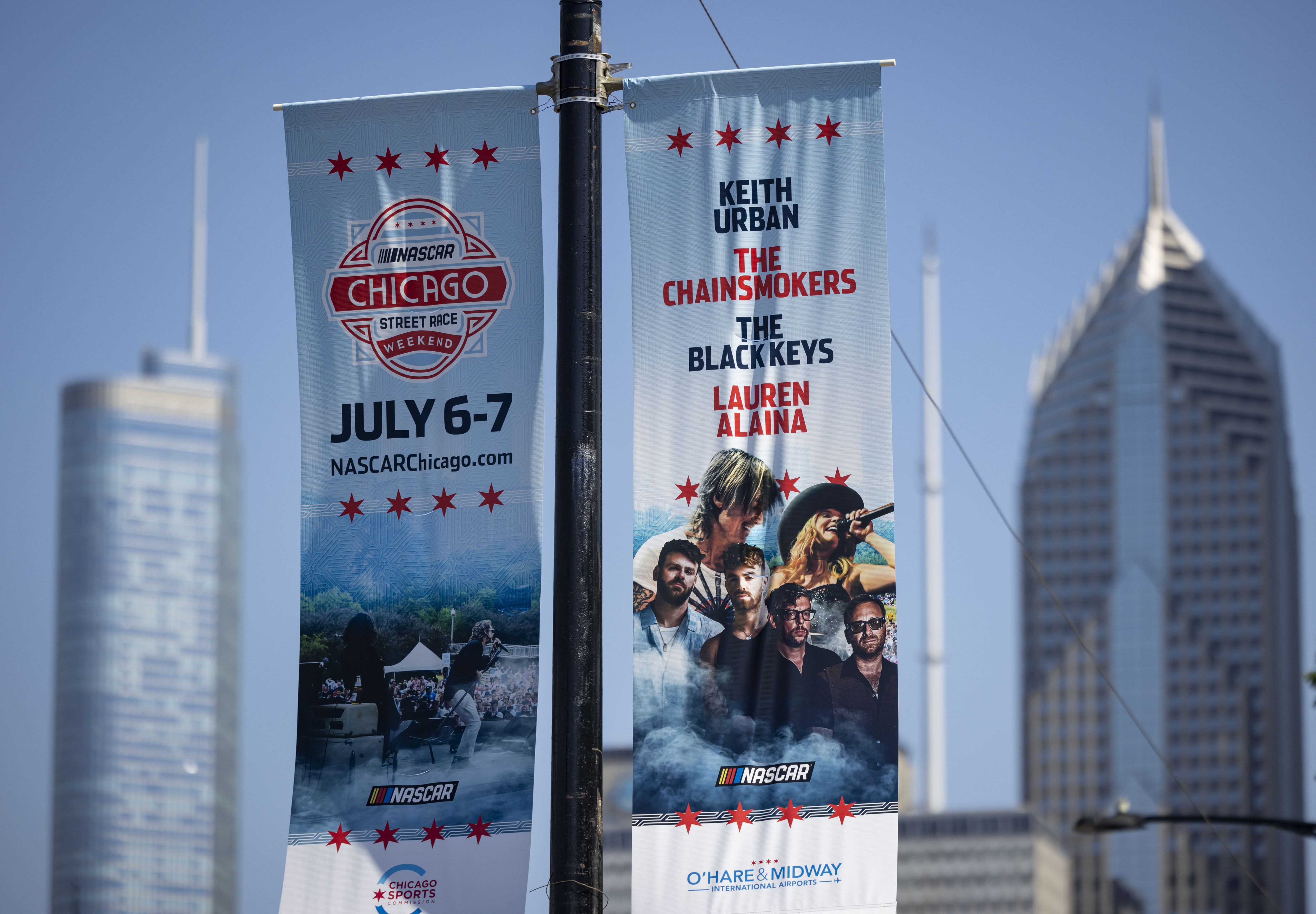 Signage is displayed on poles along Columbus Drive near Buckingham Fountain for the NASCAR Chicago Street Race on June 13, 2024, in Grant Park. (Brian Cassella/Chicago Tribune)