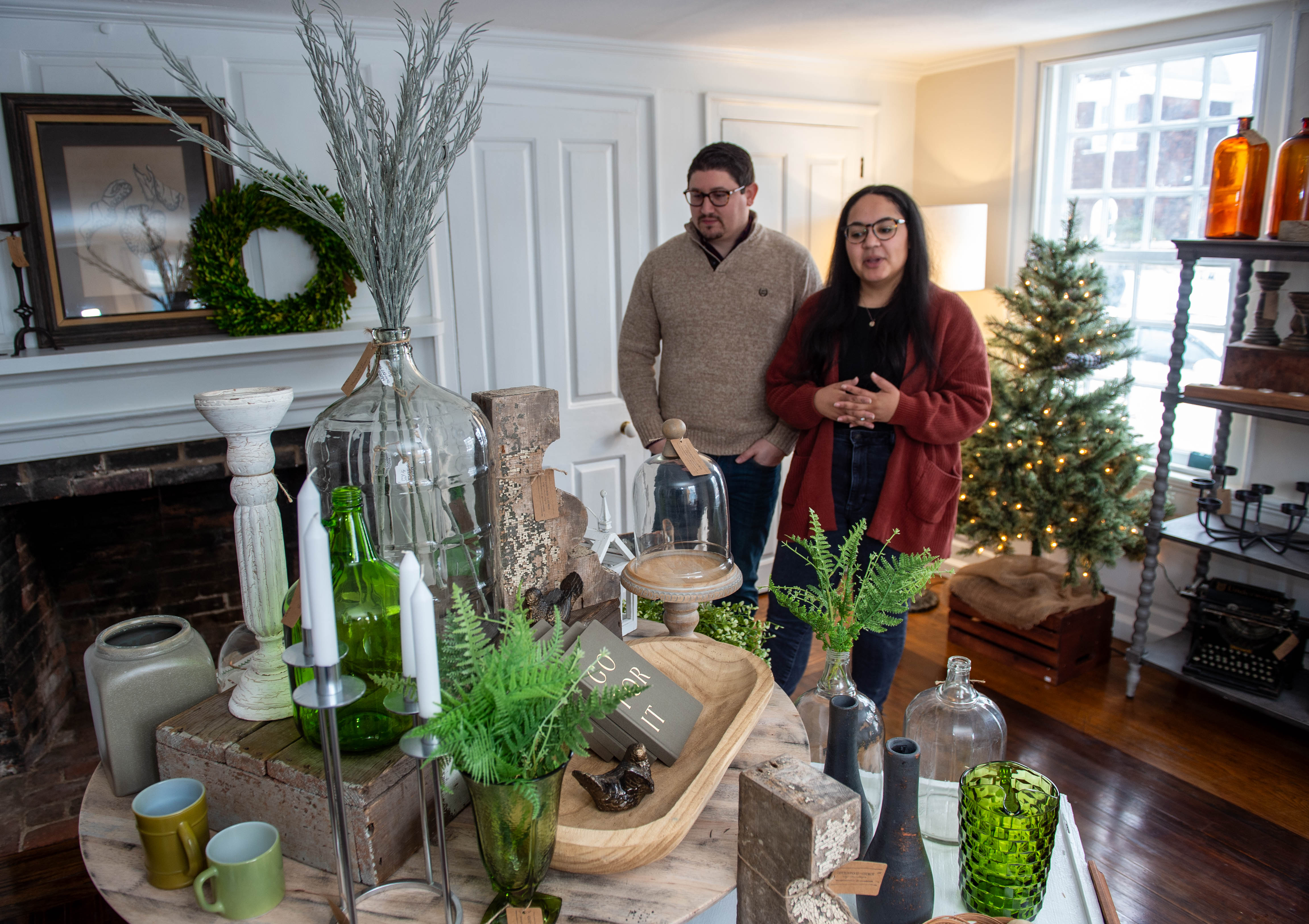 Greg and Chelsea Riendeau, owners of Cottonwood + Church, show some of the vintage and modern goods they sell at their store in Wethersfield on Friday, Jan. 19, 2024. The three stores; Birdie's, Raised On Ridge and Cottonwood + Church recently opened at 135 Main St. in Wethersfield. (Aaron Flaum/Hartford Courant)