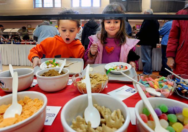 Cousins, Jackson Parrill, left, and Braidy Parrill, appear to love the oatmeal toppings during the 2012 Oatmeal Festival. (Cliff Grassmick, Daily Camera)