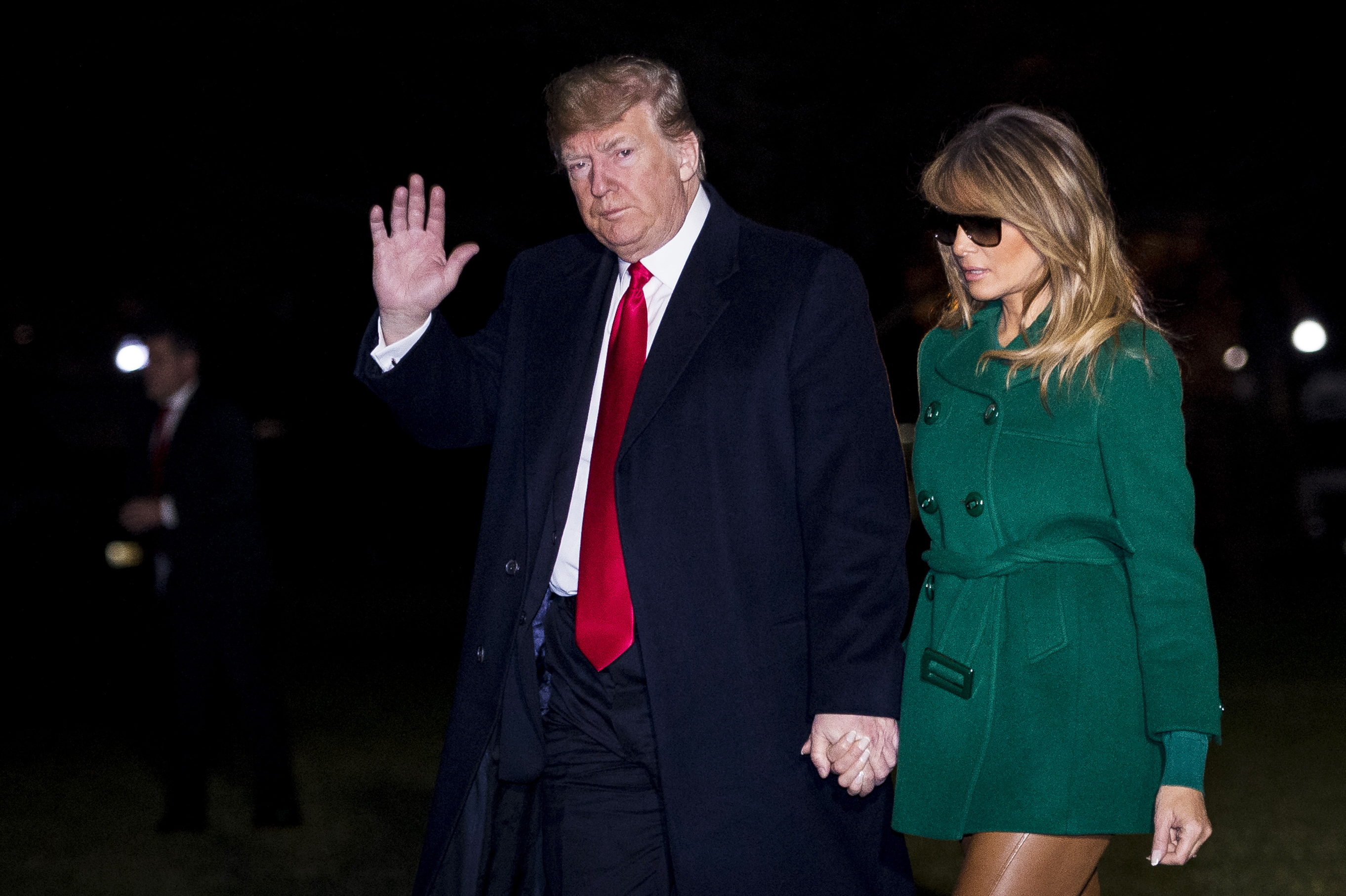 U.S. President Donald Trump and First Lady Melania Trump make their way across the South Lawn of the White House after returning on Marine One from their surprise trip to Al Asad Air Base in Iraq to visit troops, on December 27, 2018 in Washington, DC. (Photo by Pete Marovich - Pool/Getty Images)