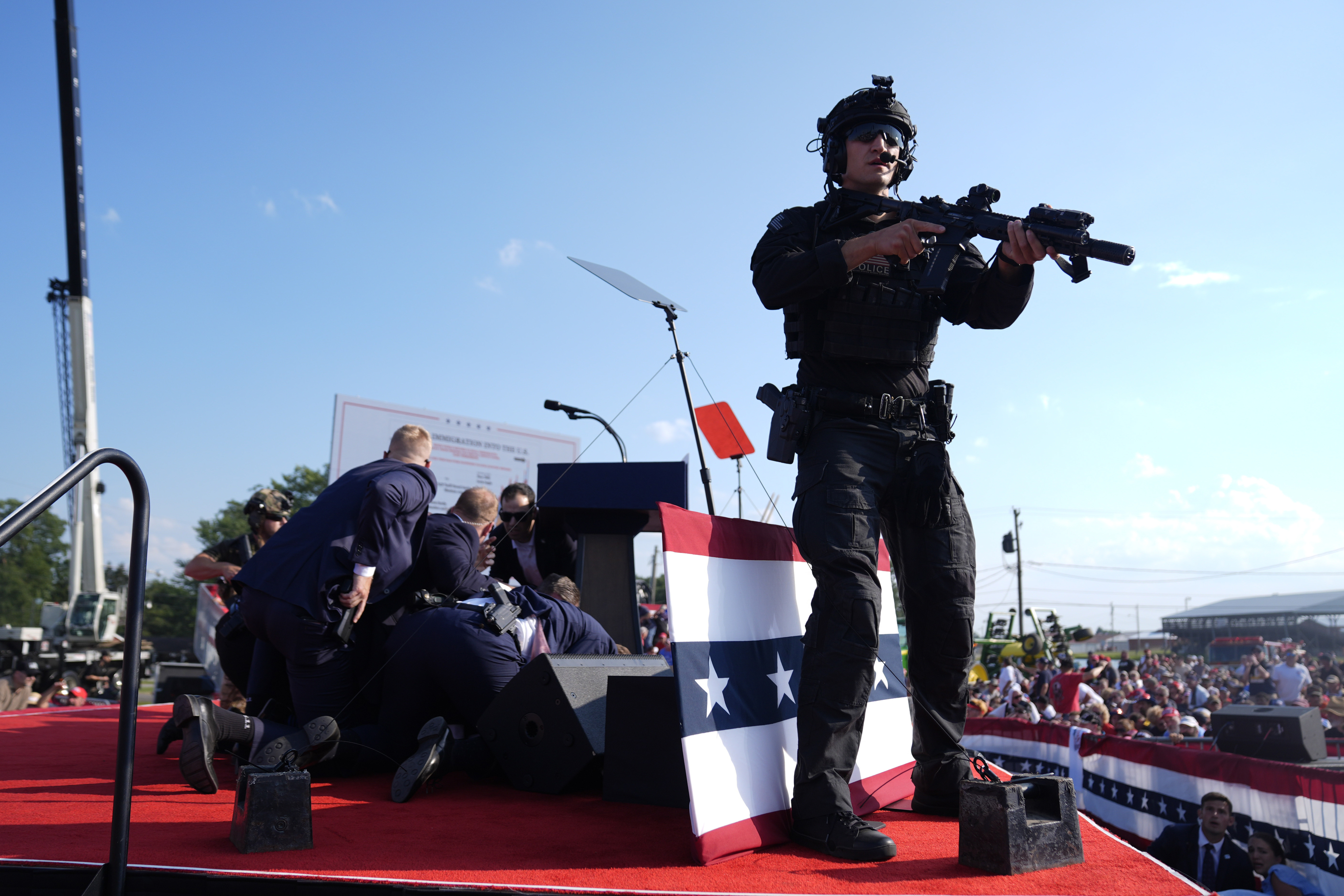 Republican presidential candidate former President Donald Trump is covered by U.S. Secret Service agents at a campaign rally, Saturday, July 13, 2024, in Butler, Pa.