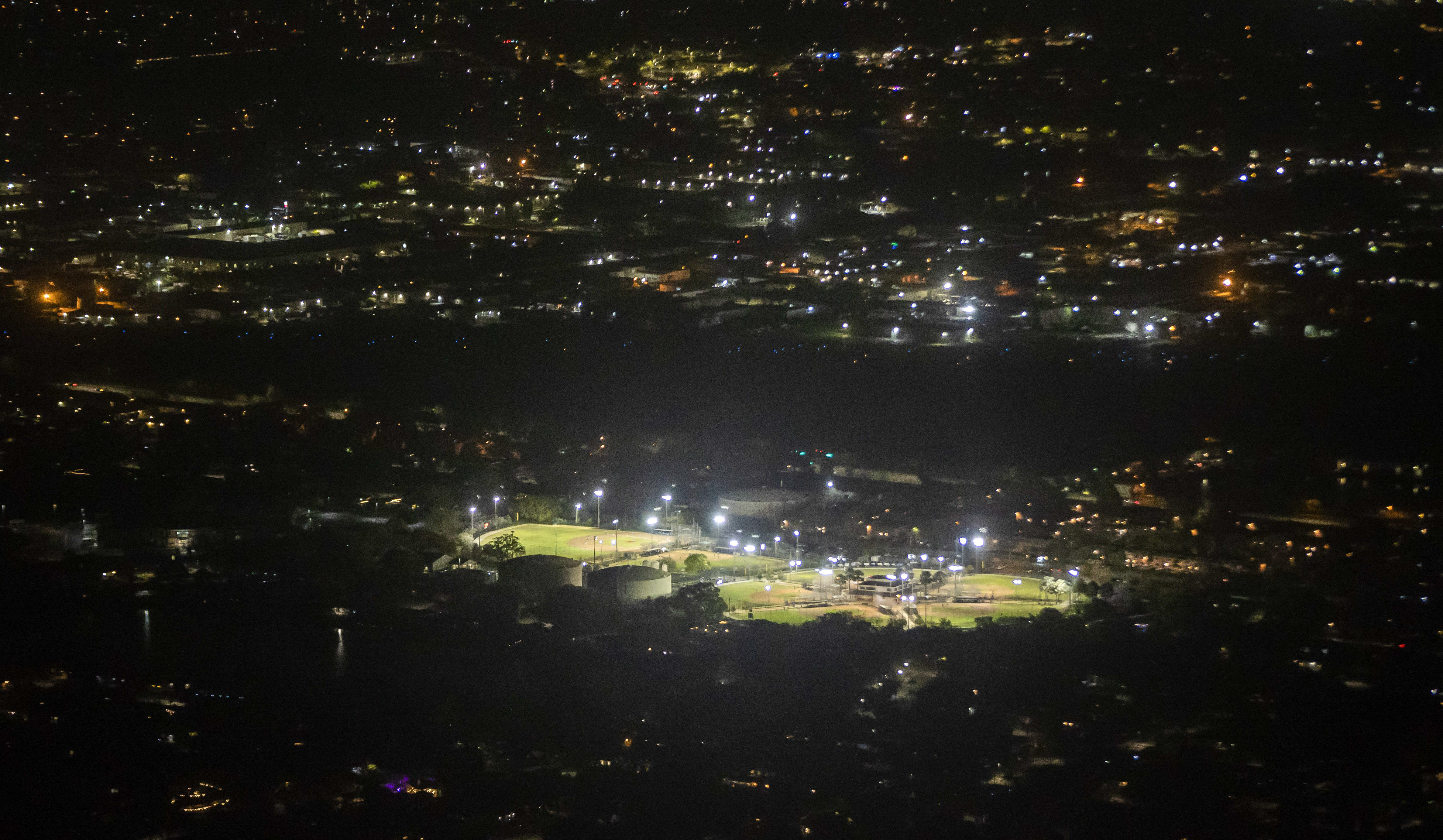 Flight instructor Ron Simonton said he often uses the lighted ballfields in the foreground as a marker when trying to find Clearwater Airpark at night. Just beyond the fields, a dark portion of land is seen where the airpark is located with its runway lights switched off on Thursday.