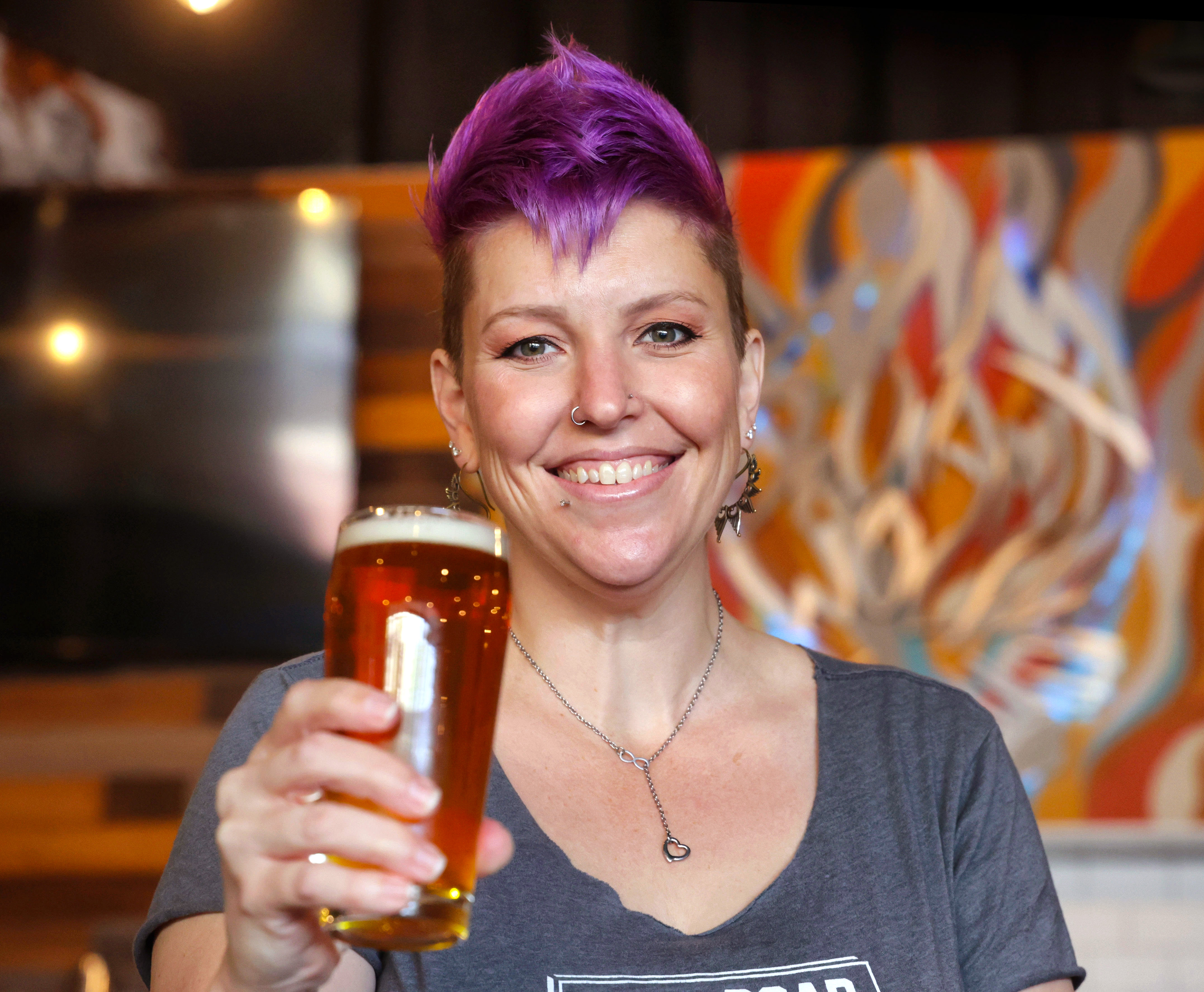 Amanda Smythe from Tollroad Brewing raises a glass at Deviant Wolfe in downtown Sanford, Thursday, May 21, 2024. (Joe Burbank/Orlando Sentinel)