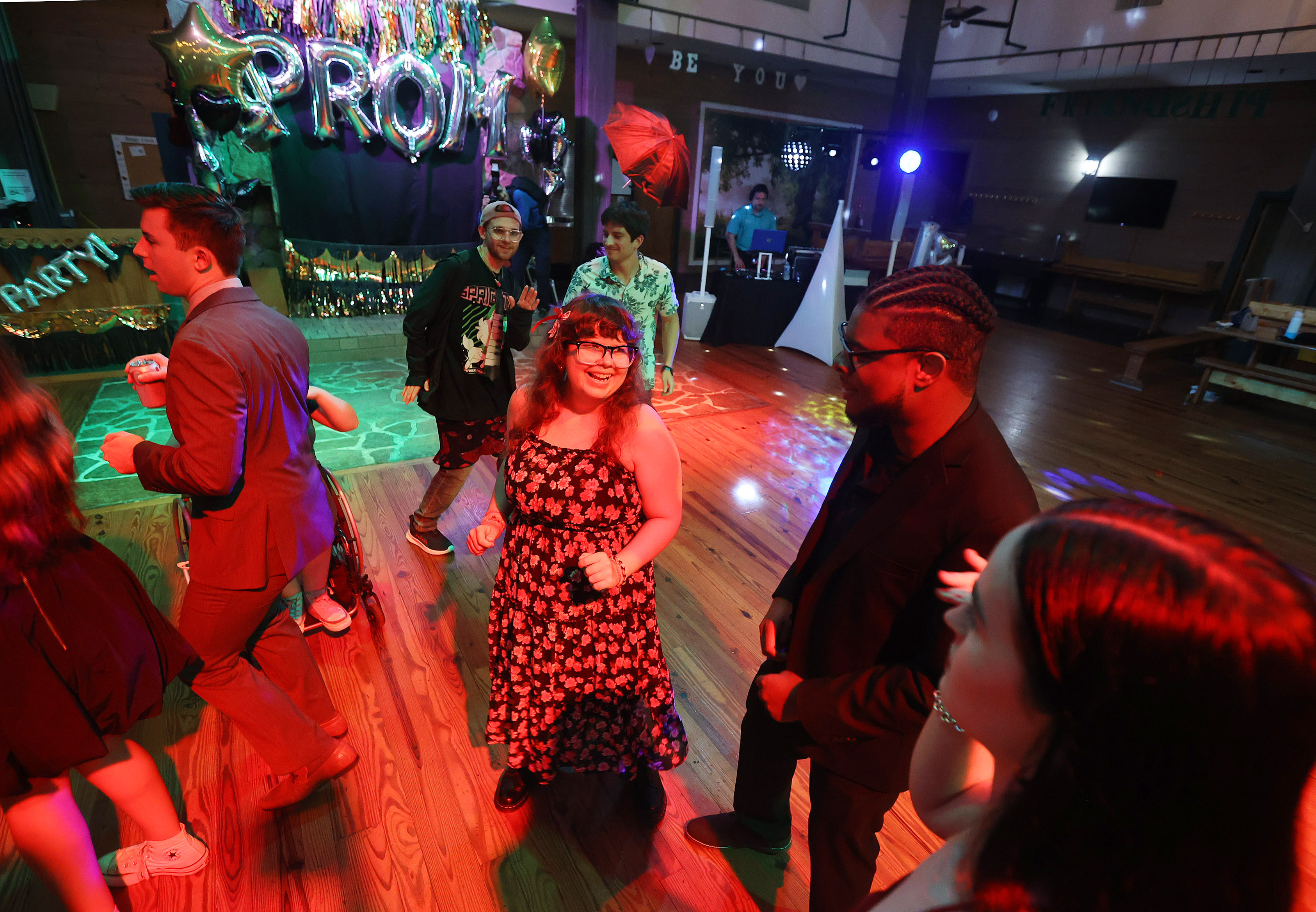 Sarah Wolfgang, middle, dances during a Camp Boggy Creek Prom for their summer staff on Tuesday evening, June 25, 2024. (Stephen M. Dowell/Orlando Sentinel)