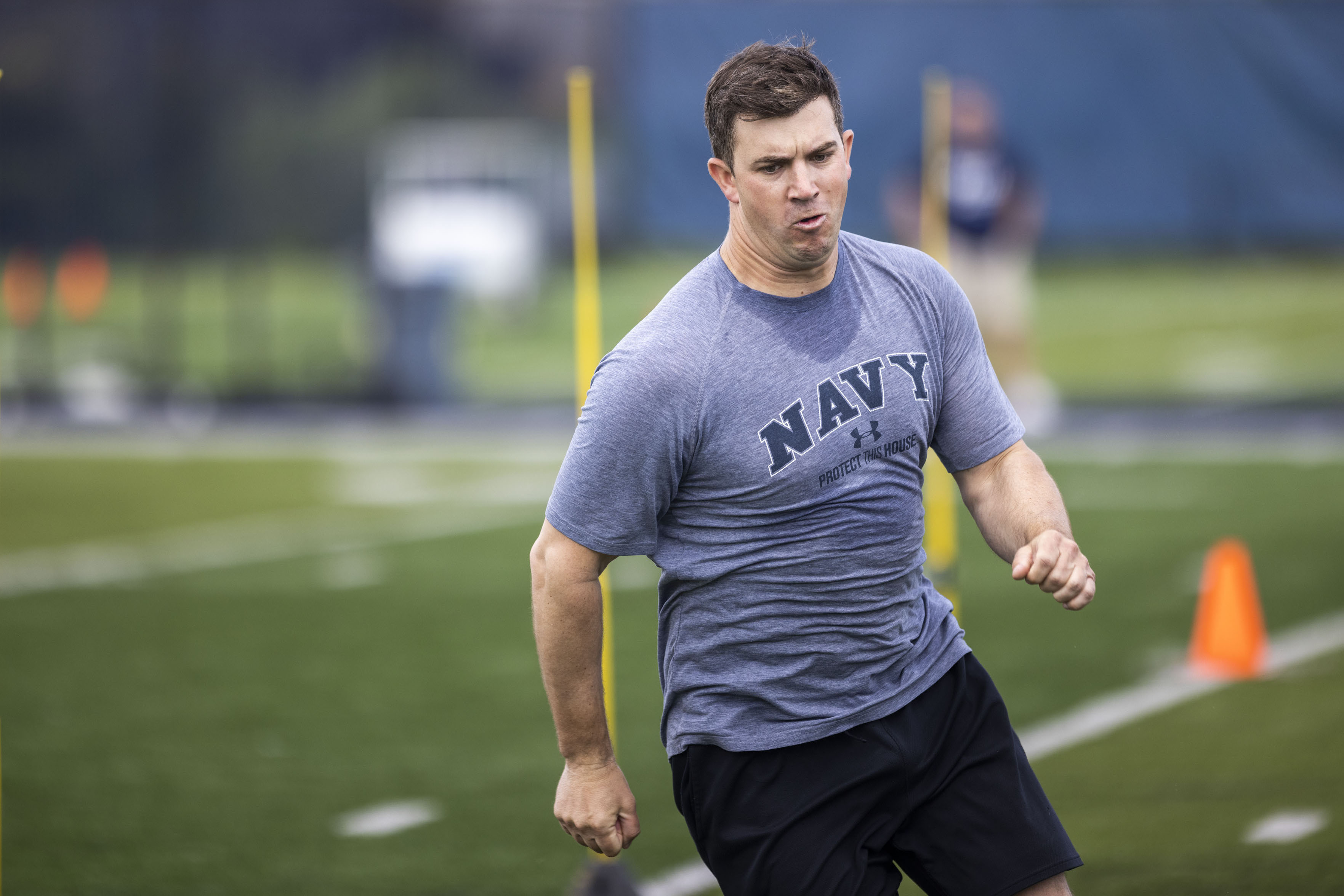 Lieutenant Marty Wilson with the Navy VFA 106 Demo Team participates in a joint workout with the ODU football team at the L.R. Hill Sports Complex in Norfolk on Thursday, June 20, 2024. (Kendall Warner / The Virginian-Pilot)