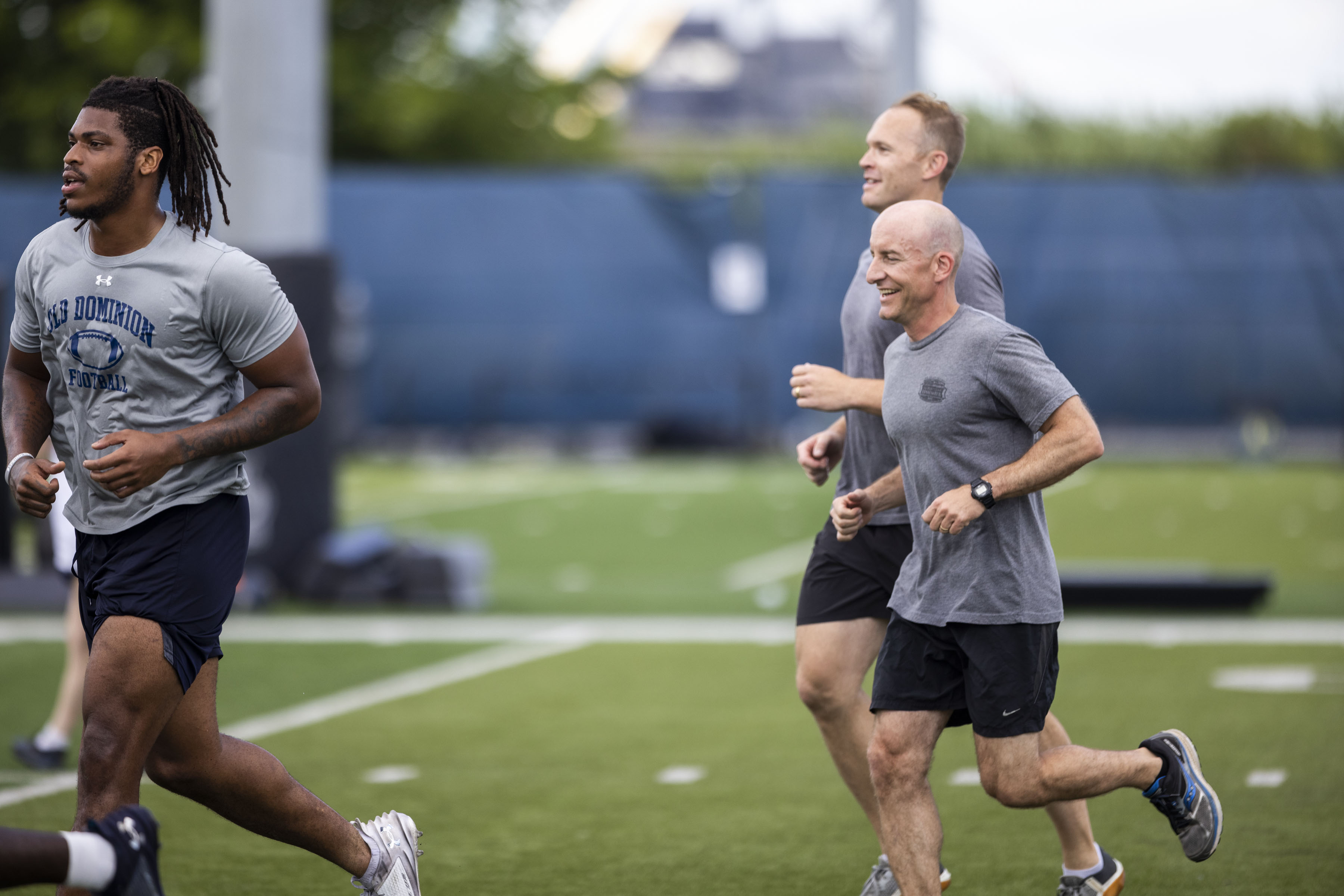 Captain Jason Papadopoulos with the Navy VFA 106 Demo Team heads to the next station during a joint workout with the ODU football team at the L.R. Hill Sports Complex in Norfolk on Thursday, June 20, 2024. (Kendall Warner / The Virginian-Pilot)