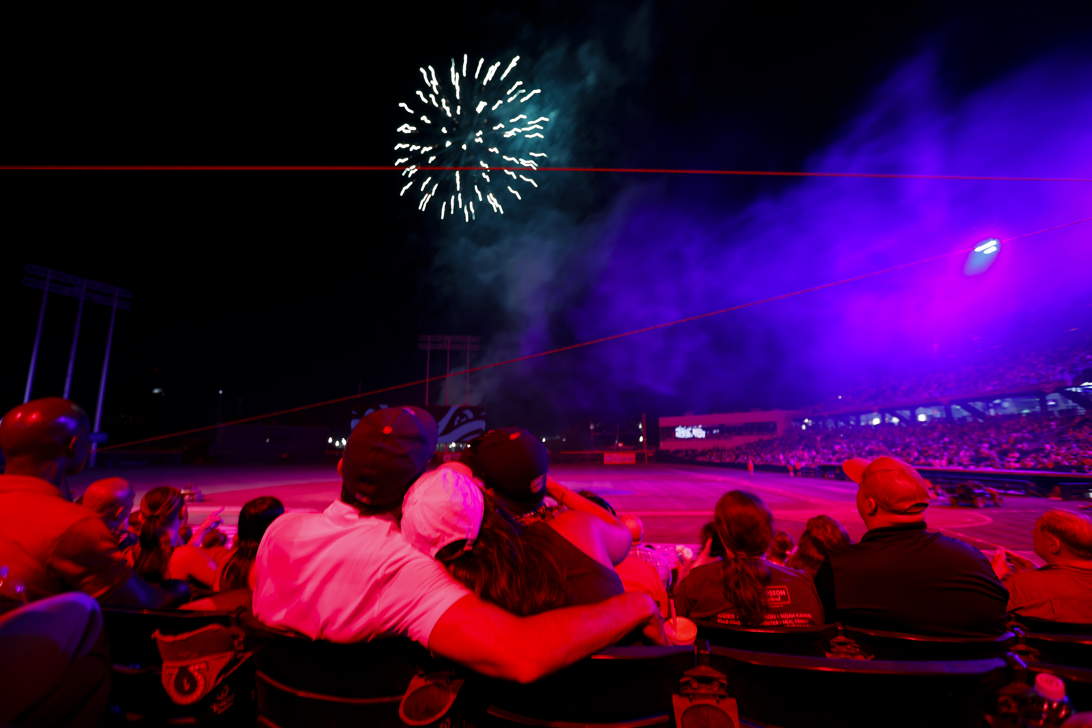 Fans take in the fireworks show following the game. The Durham Bulls defeated the Norfolk Tides 3-2 in 11 innings at Harbor Park in Norfolk, Virginia, on July 3, 2024. (Billy Schuerman / The Virginian-Pilot)