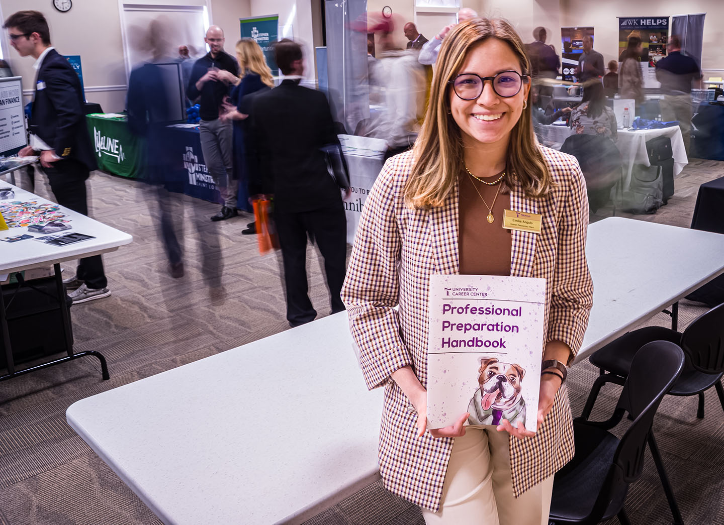 Student holding Professional Preparation Handbook