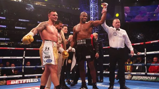 Daniel Dubois celebrates victory as Kevin Lerena reacts to defeat after the WBA World Heavyweight Title fight between Daniel Dubois and Kevin Lerena at Tottenham Hotspur Stadium on December 03, 2022 in London, England.