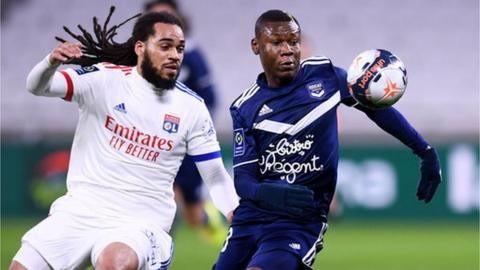 Jason Denayer and Samuel Kalu compete for the ball