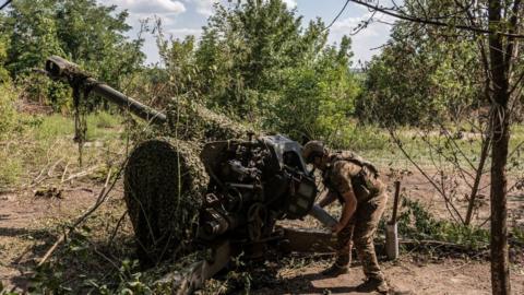 A Ukrainian serviceman preparing to fire in the direction of Bakhmut yesterday