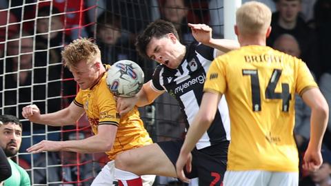 Newport's Will Evans wins a defensive header