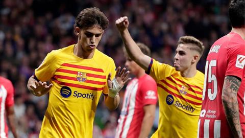 Joao Felix holds his hands up after scoring against Atletico Madrid