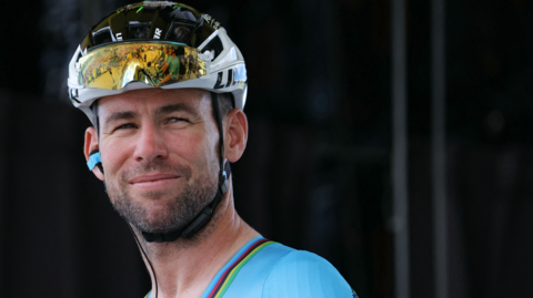 Sir Mark Cavendish wearing a cycling helmet and reflective glasses