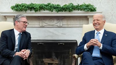 Keir Starmer and Joe Biden sit in low cream-coloured chairs