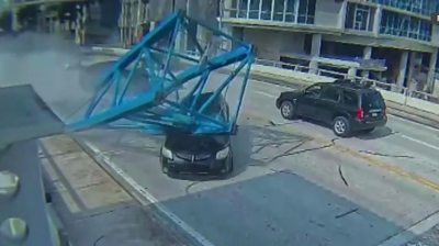 Crane crushes car