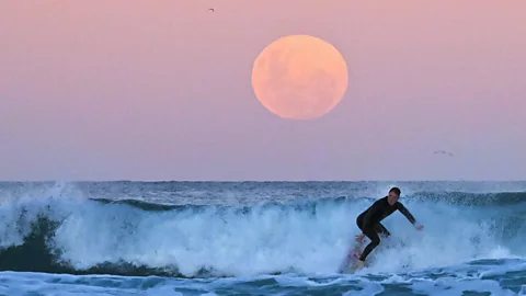 Steven Saphore/Anadolu Agency/Getty Images The gravitational tug of the Moon on the Earth's oceans creates the tides, which in turn drag the Moon into a higher orbit (Credit: Steven Saphore/Anadolu Agency/Getty Images)