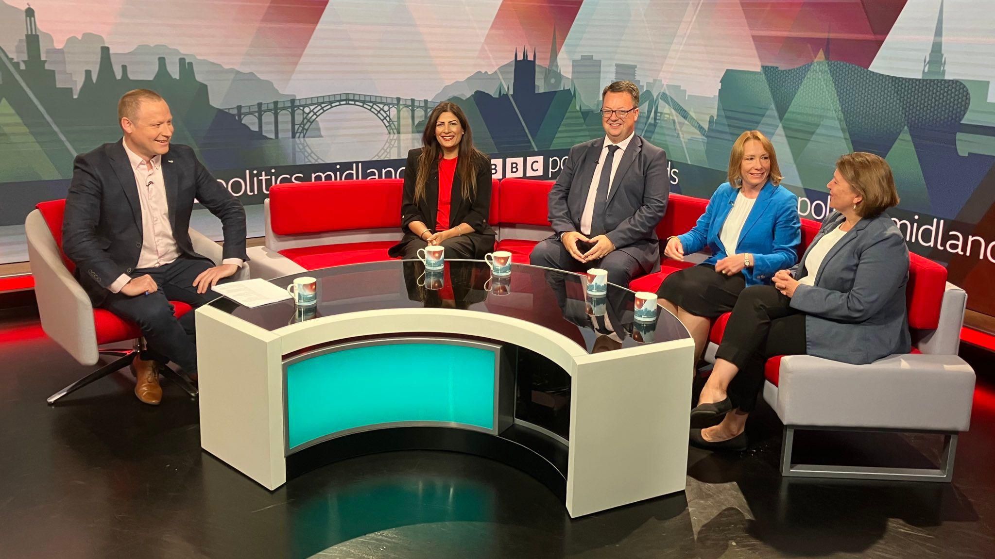 The guests on BBC Politics Midlands. Four MPs, three women and one man, sit on a circular couch opposite host Rob Mayor