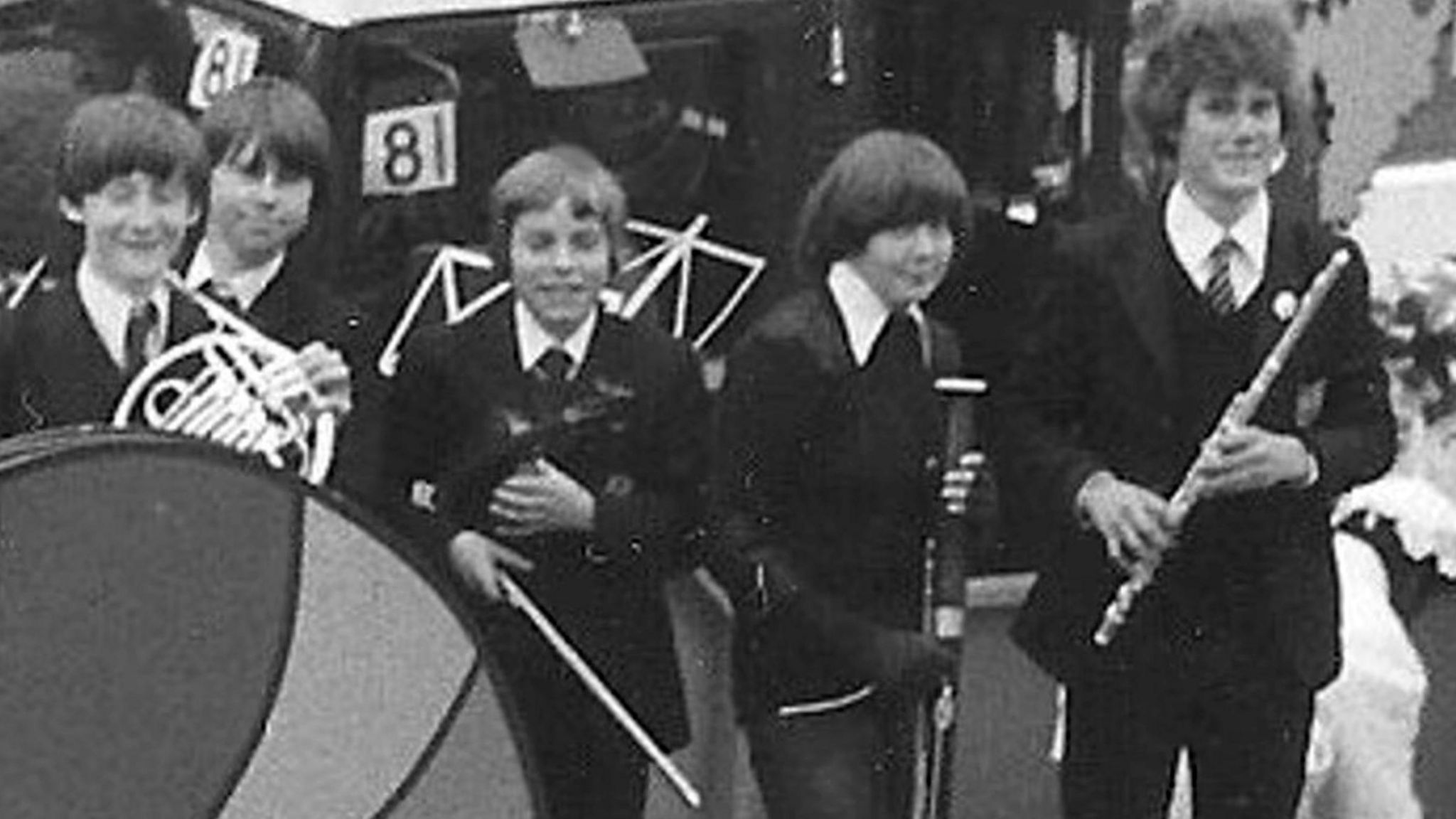 Keir Starmer, in school uniform and holding a flute, stands alongside fellow school musicians