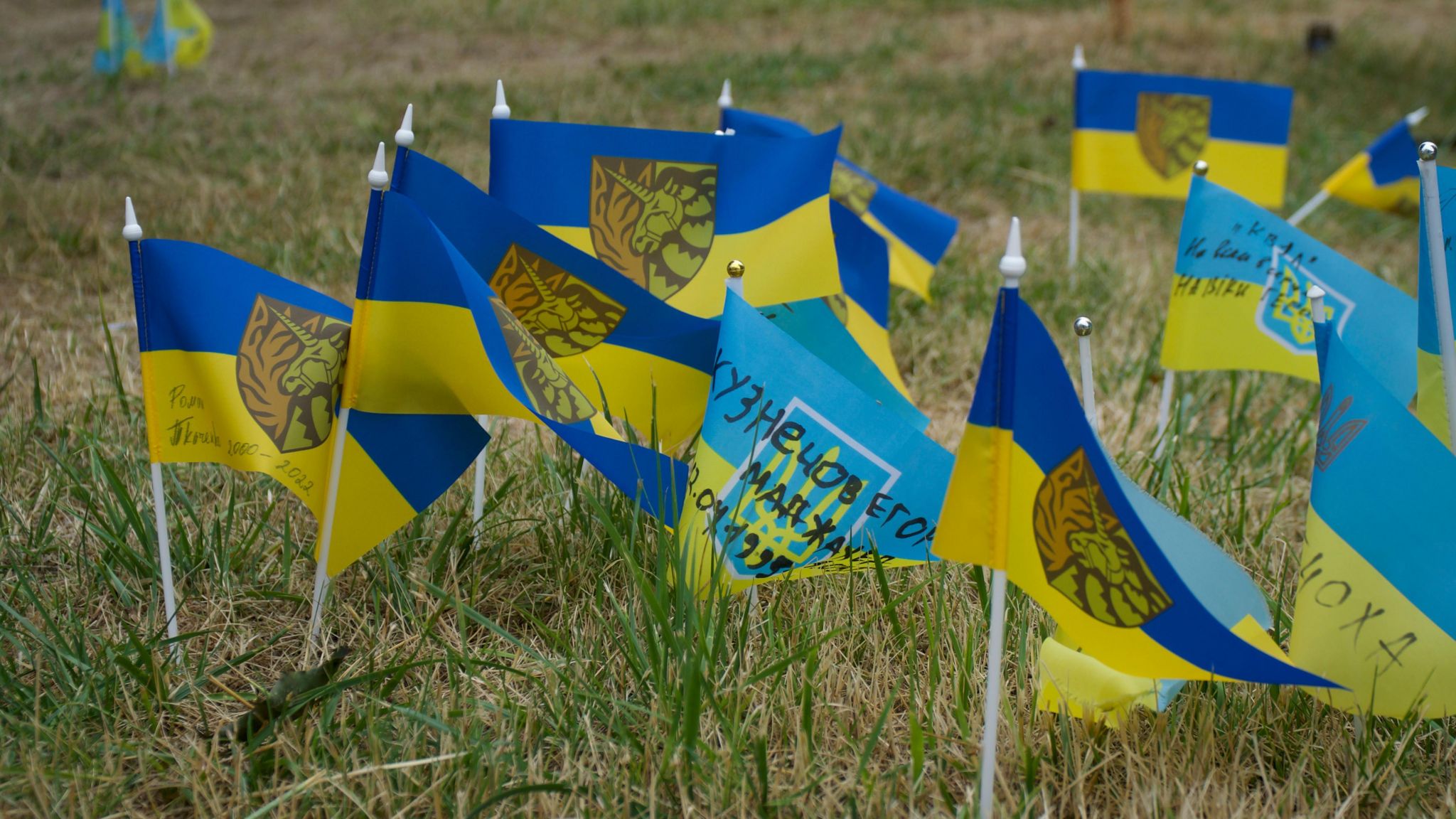 Ukrainian flags are seen, representing fallen soldiers