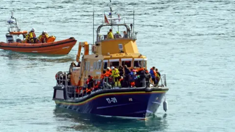 PA Media Migrants on a lifeboat on 20 March 2024