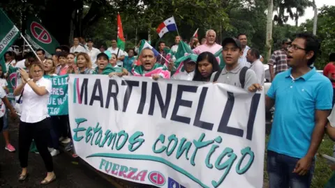 Reuters Supporters of former Panama president Ricardo Martinelli hold a banner reading: "Martinelli, we are with you" during a protest outside the Supreme Court in Panama City, Panama June 11, 2018
