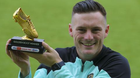 Macaulay Langstaff poses with the League Two golden boot for the 2023-24 season