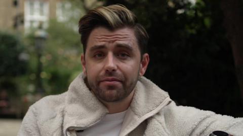 Jarryd Nurden, a man with brown and blonde hair and stubble in a cream fleece