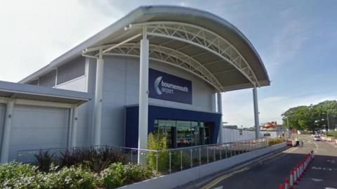 The front of Bournemouth Airports terminal with a road running in front