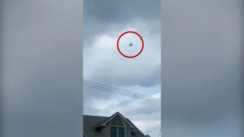 A drone is seen flying over a home.