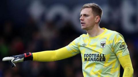 Alex Bass in action for AFC Wimbledon