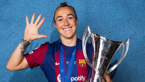 Lucy Bronze holds the Women's Champions League trophy