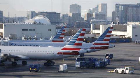 American Airlines planes parked at gates.