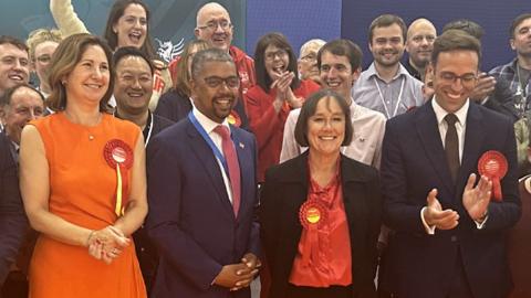 Wales' First Minister Vaughan Gething with winning Labour candidates and supporters at the count in Cardiff 