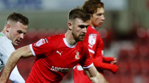 Swindon's Harrison Minturn in action against Exeter City