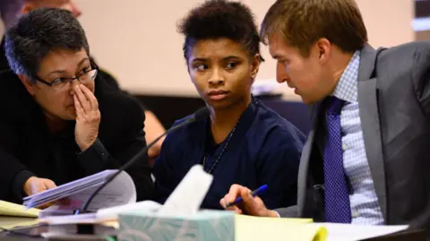 Chrystul Kizer sits with her lawyers during a hearing in the Kenosha County Courthouse on 15 November 2019