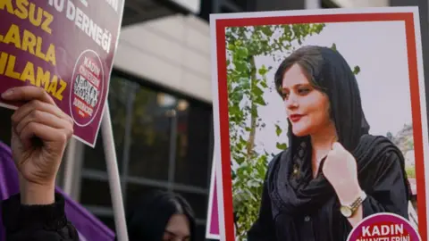 Getty Images A protester holds a picture of Mahsa Amini during protests in Turkey back in 2022