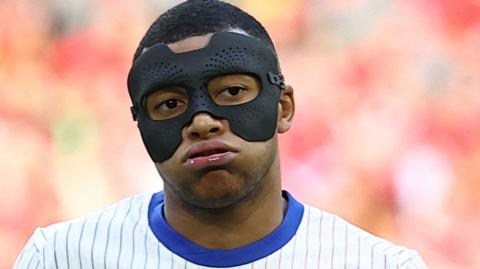 Kylian Mbappe wearing a mask