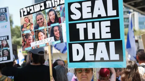 Reuters A woman holds up a sign saying "Seal the deal" at a protest calling for a Gaza ceasefire and hostage release deal in Tel Aviv, Israel (2 September 2024)