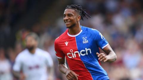 Michael Olise smiles while in action for Crystal Palace