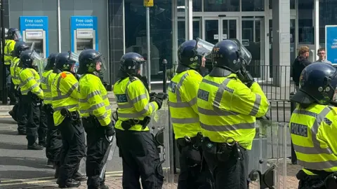 Riot police lined up in a street in Stoke-on-Trent