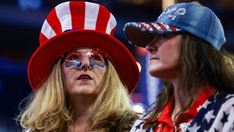 Women wearing stars and stripes clothes wait for the start on the third day of the Republican National Convention at the Fiserv Forum on 17 July 2024 in Milwaukee, Wisconsin, US
