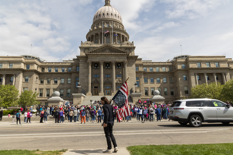 protestor holds an upside down flag at a Planned Parenthood rally about the EMTALA case in Boise, Idaho